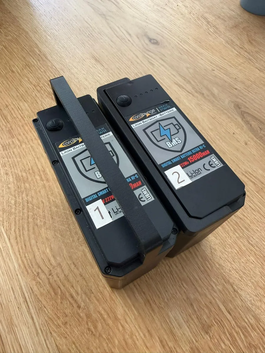 Twee Smart-accu's van de Carplounge met de zwarte vervangende hendel omhoog als draaggreep
